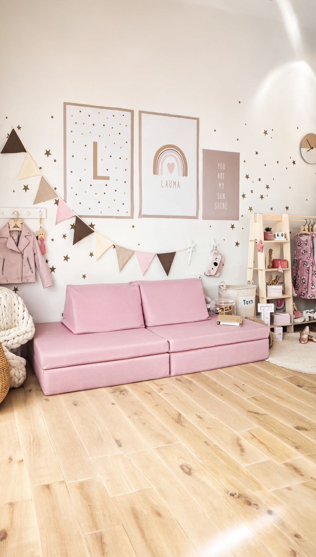 Pink sofa in a room with decorative elements and a light wooden floor.