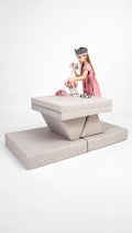 Child playing with a toy on a modern, elevated platform against a white background