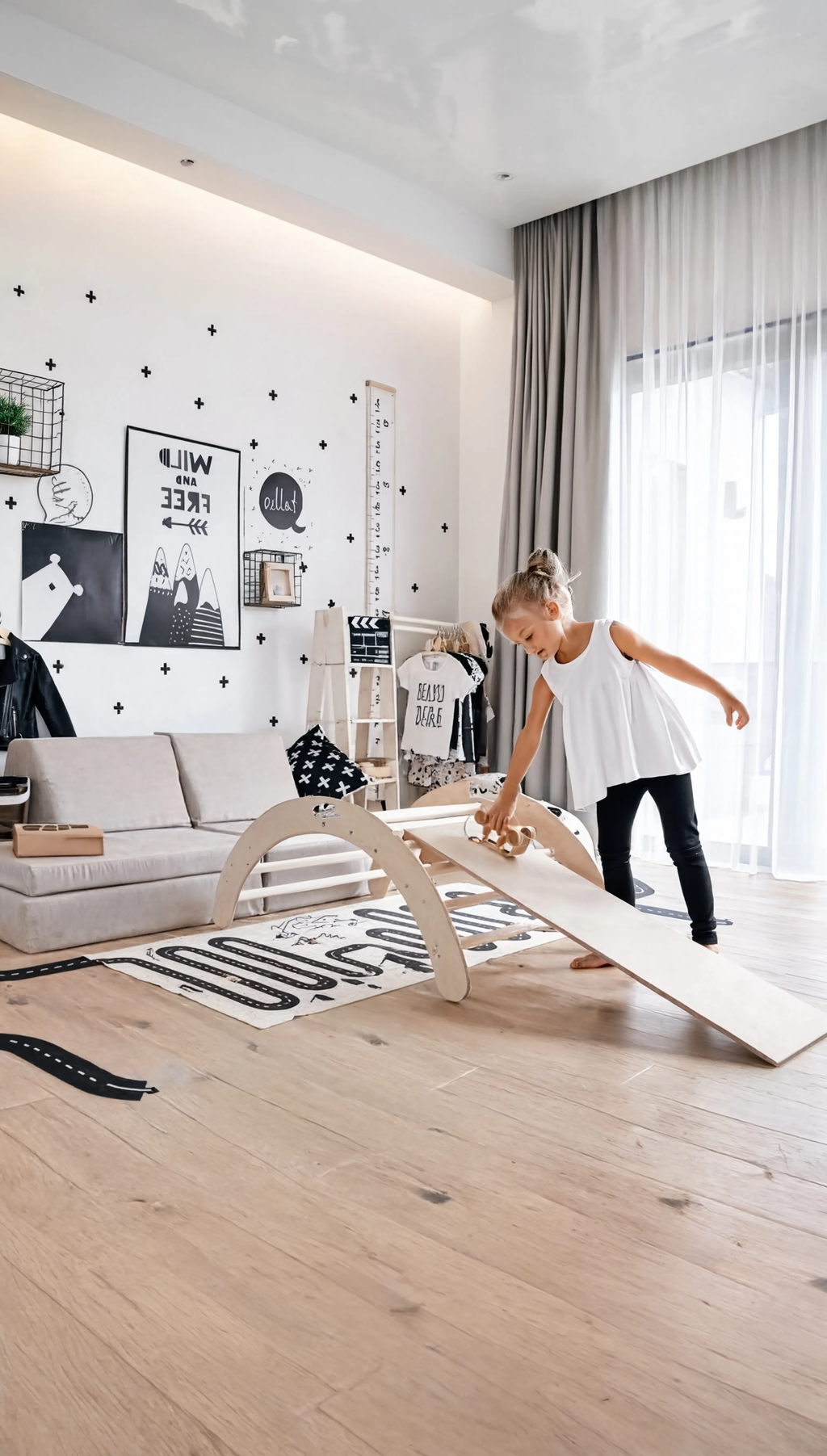 Child playing with a wooden balance beam in a modern living room.